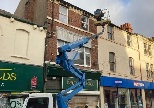 Emergency roof repair Barrow — cherry picker on town centre storefronts