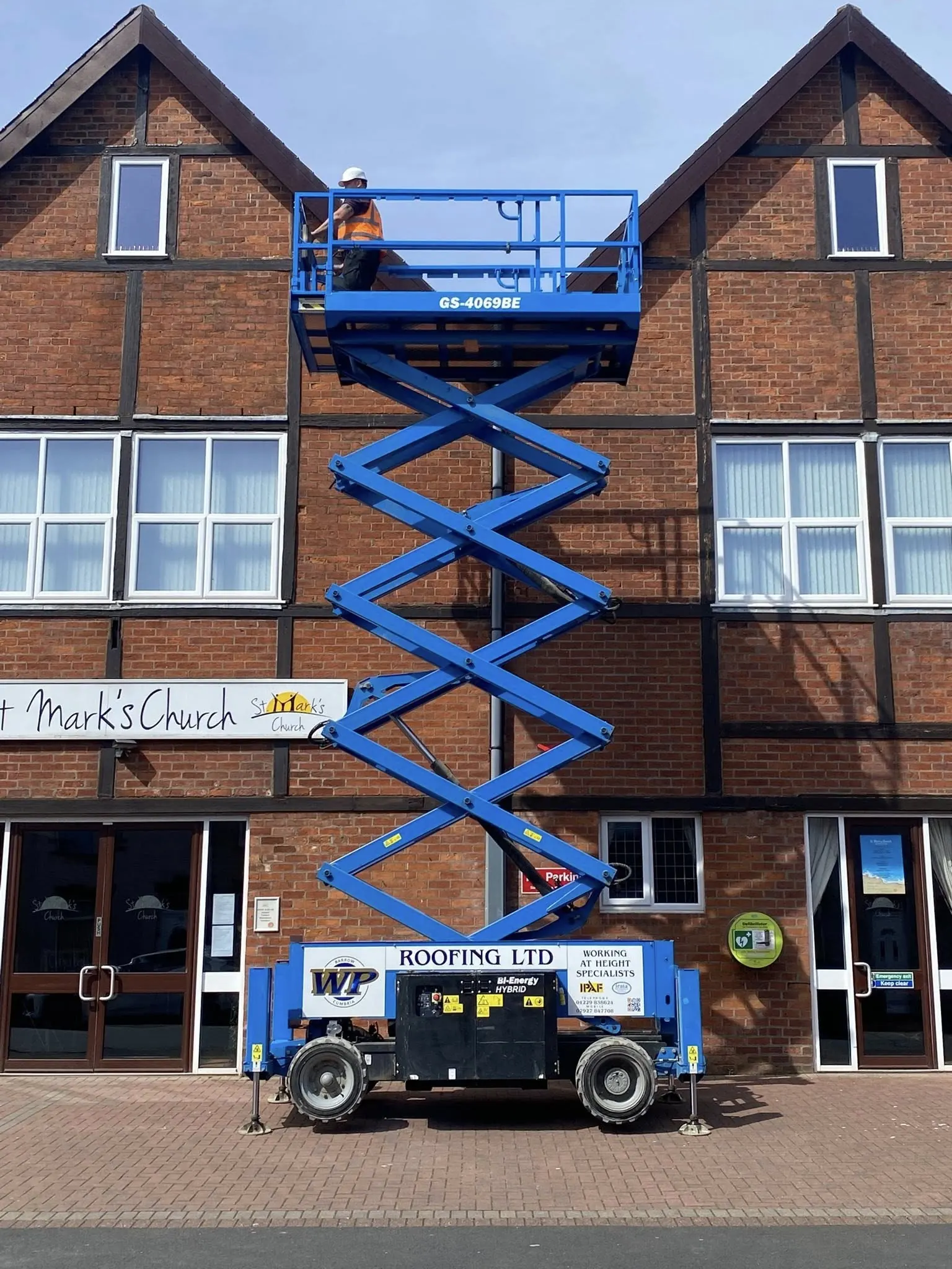 WP Roofing scissor lift working at heights on St Mark's Church, Barrow-in-Furness
